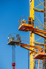 Several boom lifts in action