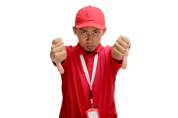 Displeased Asian Delivery man or courier is showing a thumb down gesture, giving bad review, low rating, feedback. Isolated on a white background