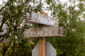 High surf and ocean drive street sign on a wooden post