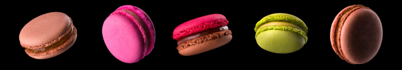 Macro photo of french caramel macaroon or macaron isolated on black background