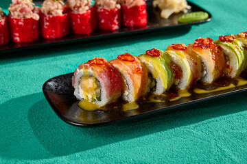 Sushi Assortment with Salmon, Avocado, and Tuna on Black Plates