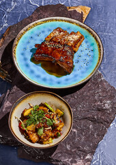 Delicious Meat Dishes Display Grilled Pork Ribs and Seasoned Vegetables on Rustic Plates