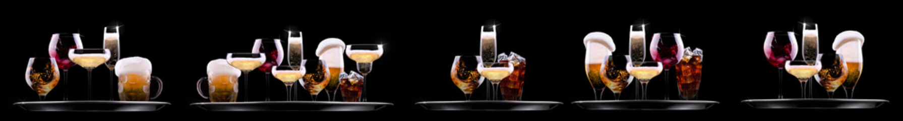 Hand holding tray with different alcohol cocktails isolated on black background