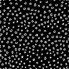 Seamless pattern of white curls on a black background.