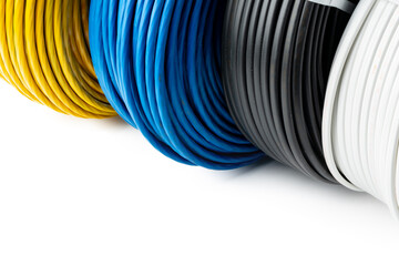 Four Spools of Electrical Wire in Yellow, Blue, Black, and White Colors: A Close-Up 