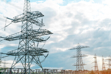 Tall Steel Transmission Towers Against Cloudy Sky