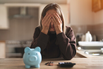 Woman In Kitchen Feeling Overwhelmed By Finances