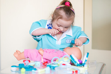 A young girl with Down syndrome playing with a plastic toy medical kit. Promoting child development...