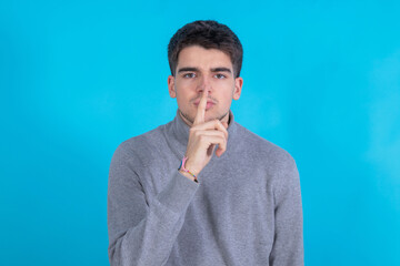 isolated young man with silence gesture