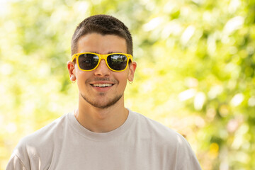 portrait of young man with sunglasses outdoors