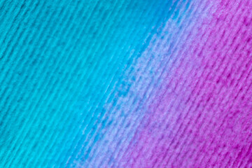 close up of striped watercolor paper stained with purple and turquoise paints