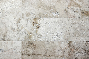 Beige gray wall made of limestone blocks. Background photo texture