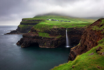 The iconic waterfall of mulafossur, gasadalur, vagar, faroe islands, denmark, northern europe,...