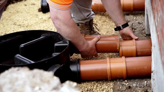 Installing Drain Pipes Near Concrete Foundation in Backyard