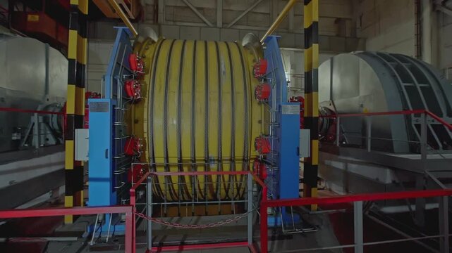 Mechanism with ropes for mines. Stock clip. Drum of winch of mine lifting system in production. Multiple ropes on drum for mine lifting system