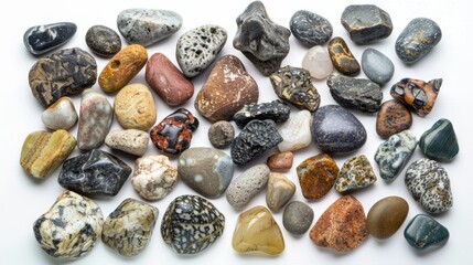 Assortment of rocks and pebbles of different colors and sizes, white background