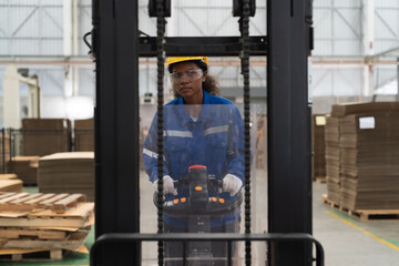 Female warehouse worker driving and operating on forklift truck for transfer products or parcel goods at storage warehouse