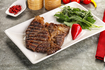 Grilled chuck roll steak with arugula