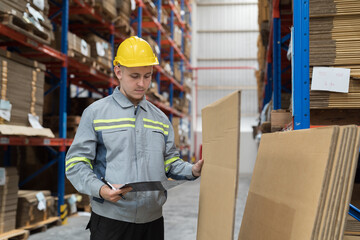 Male warehouse worker checking inventory in warehouse