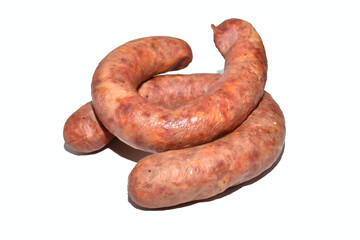 On a white background lies a sausage made from pork meat with the addition of garlic.