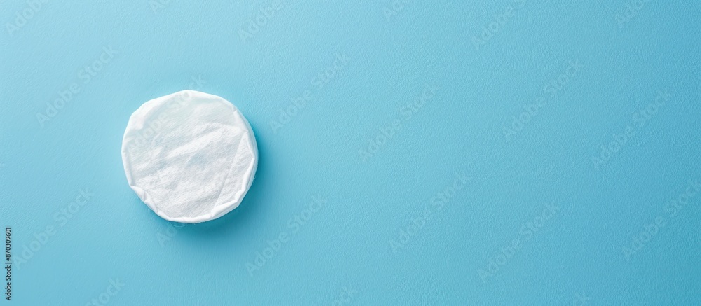 Poster blue background with makeup remover and cotton pad displayed, offering copy space for text.