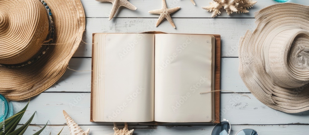 Poster Flat lay with copy space image featuring a blank writing book surrounded by summer beach accessories in the background.