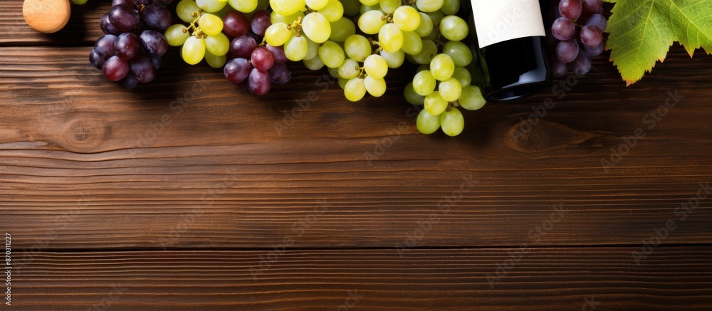 Aufkleber Top down view of assortment of wine bottles and grapes displayed on a rustic wooden surface, providing a blank area for text or design known as a copy space image.