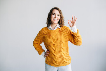 Confident Woman Gesturing OK. Smiling Lady Recommends Product with Hand Sign - Advertising Concept...