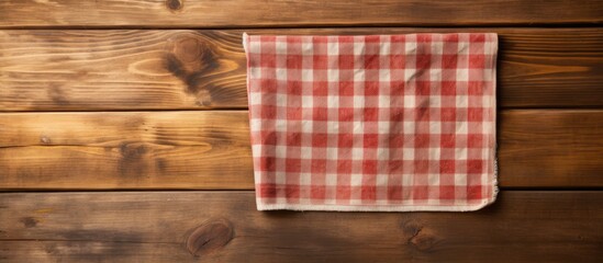 Obraz premium Wooden cutting board and kitchen towel on a wooden surface providing ample copy space image.