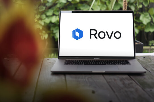 Rovo logo, collaboration tool designed by Atlassian for remote teams, offering chat, video calls, and project management features, displayed on MacBook Pro screen