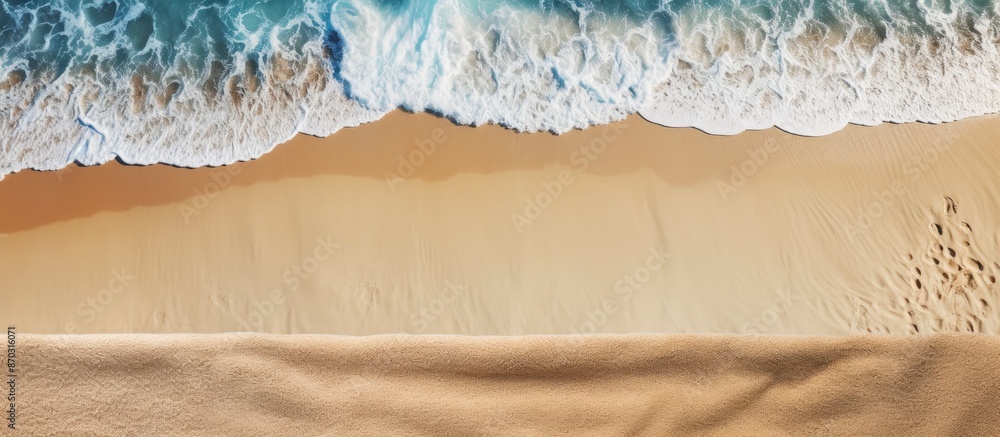Aufkleber Sandy beach seen from above with towel border, summer accessories, and visible sand texture, creating a background with copy space image on the left side.