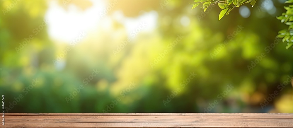 Poster outdoor template featuring a wooden table with a green sunny bokeh, ideal for showcasing your produc