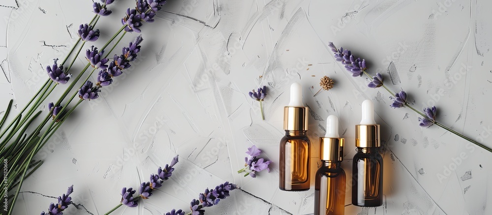 Poster Gray background with unbranded cosmetic serum bottles and lavender bunch in a top view flat lay composition, featuring copy space.