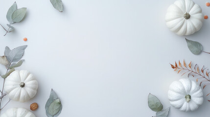 A flat lay image featuring white pumpkins and eucalyptus leaves on a white background with copy space