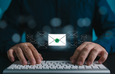 Email marketing concept. A person or customer uses keyboard to send or read an email or digital...