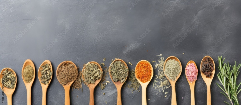 Poster Top view of wooden spoons holding herbal tea on a gray cement backdrop, suitable for children's immunity, with empty space for text or images. with copy space image. Place for adding text or design
