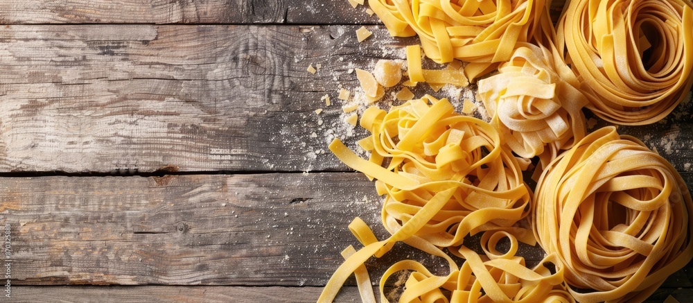 Aufkleber Tagliatelle and assorted pasta rest on a stone and wood backdrop in a composition with ample copy space image.