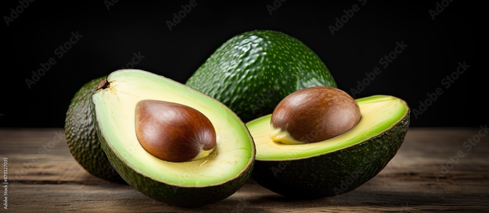 Poster Fresh ripe avocado fruit sliced in half with a white background and space for text or images. with copy space image. Place for adding text or design