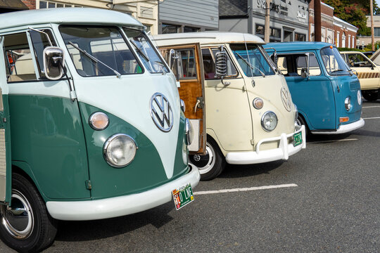 Snohomish, WA, USA - 24 September 2023. Line of Green, beige and blue 1965 Volkswagen Bus 13 Window Deluxe at car exhibition