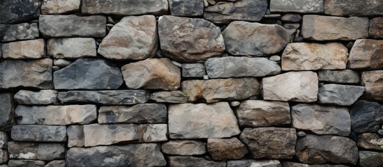 Fototapeta premium An up-close view of the stones on a stone wall with copy space image.