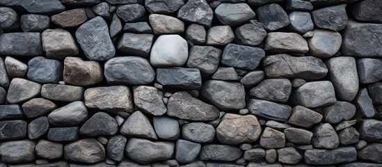 An up-close view of the stones on a stone wall with copy space image.
