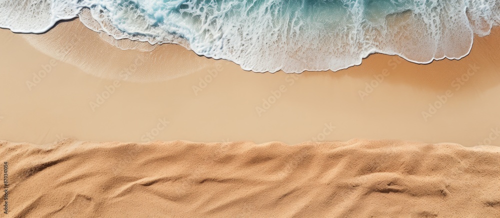 Aufkleber Sandy beach seen from above with towel border, summer accessories, and visible sand texture, creating a background with copy space image on the left side.