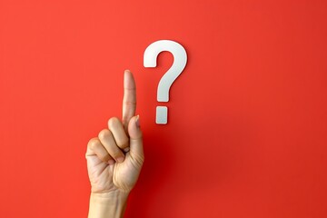 Female hand pointing at question mark on blue background