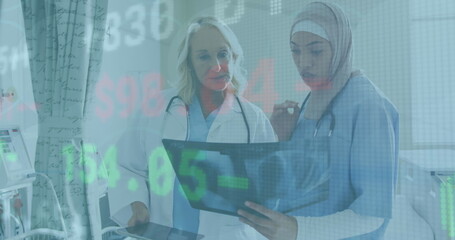 Image of data processing over diverse female doctor and healthworker examining x-ray report