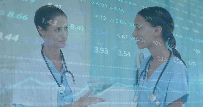 Image of stock market data processing over diverse female doctor and healthworker discussing