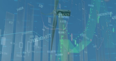 Image of graphs and changing numbers over windmills against clear sky