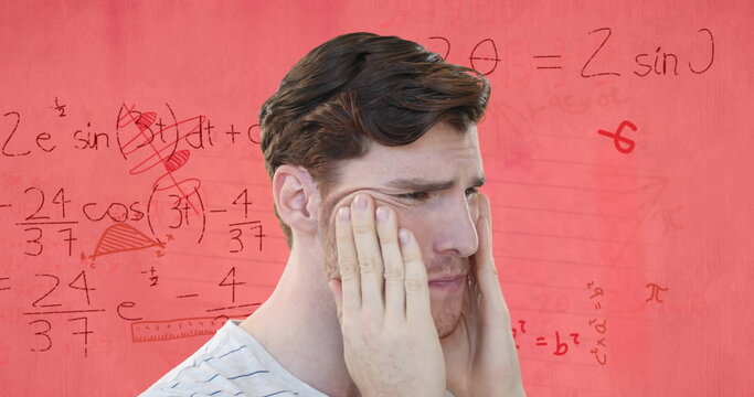 Image of stressed caucasian male student over maths equations and geometry on pink paper