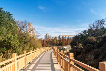 Wooden bridge over little river in city park