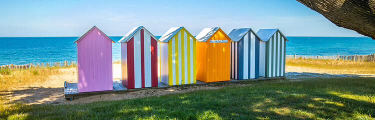 Naklejka premium Panoramic view of colored wooden beach huts of the beach of La Bree-les-Bains, France