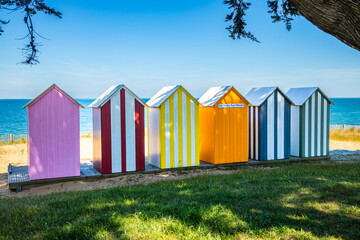 Naklejka premium Colored wooden beach huts of La Bree-les-Bains, France on a sunny day of summer
